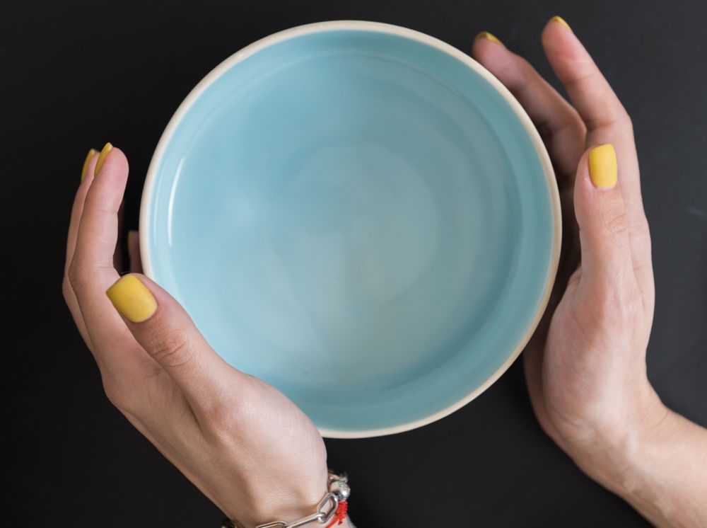 Three small irregular ceramic plates on neutral linen.